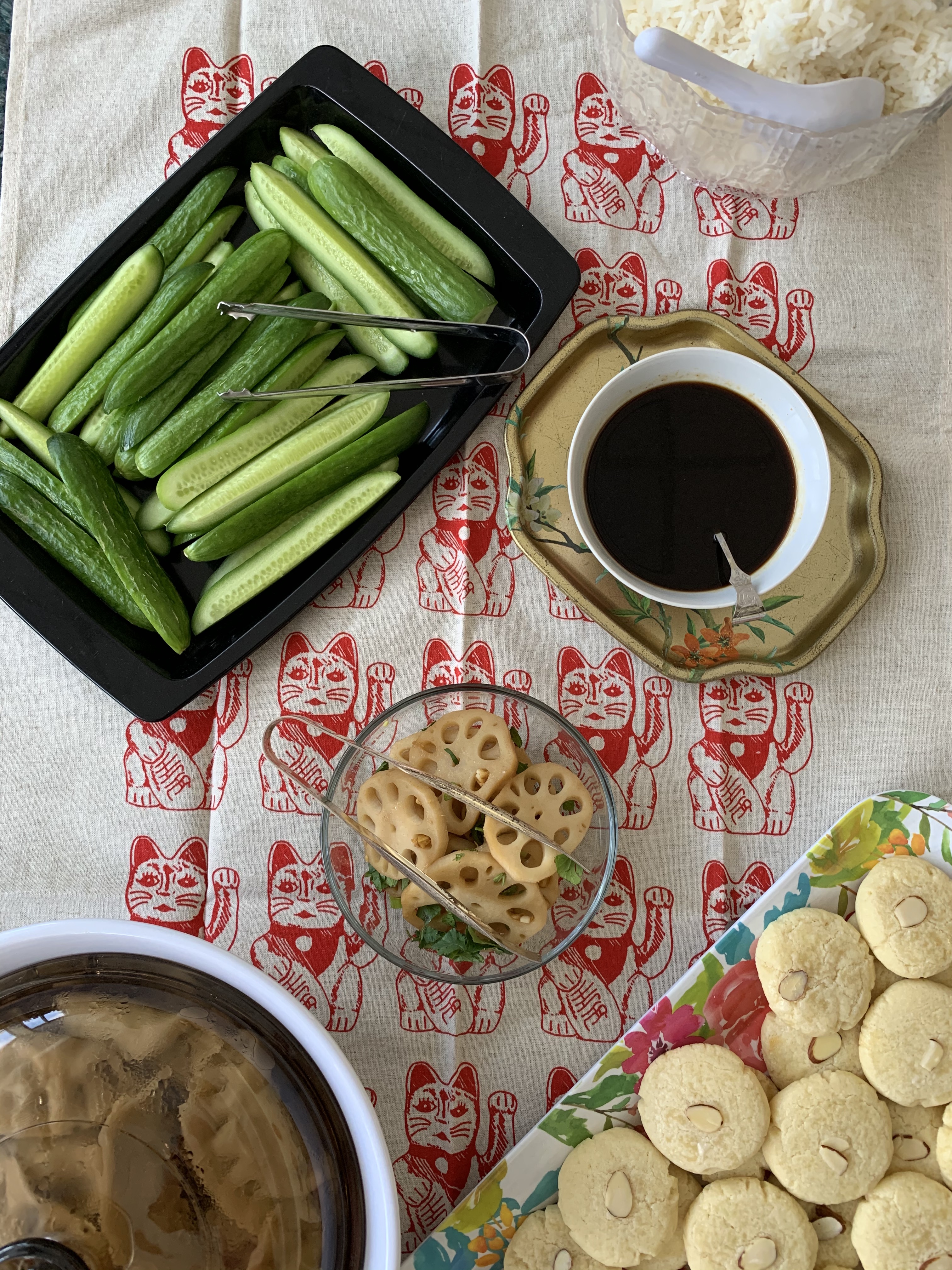 Image of cucumber slices, soy sauce, dumplings, lotus root, and almond cookies at a school party for Lunar New Year