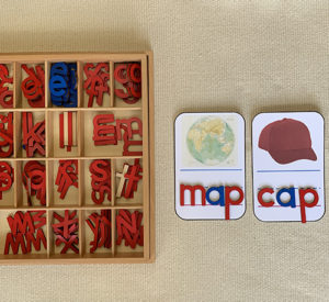 Moveable alphabet with two words spelled in red and blue letters: map, cap.