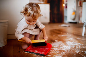 Child sweeping spilled flour.